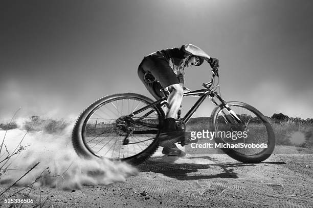 b&w extreme mountain biker jumping off a cliff - sked stock pictures, royalty-free photos & images