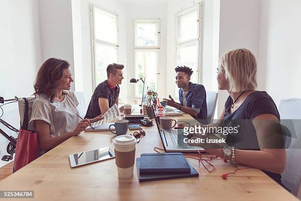 co-workers in the office - funky office stock pictures, royalty-free photos & images