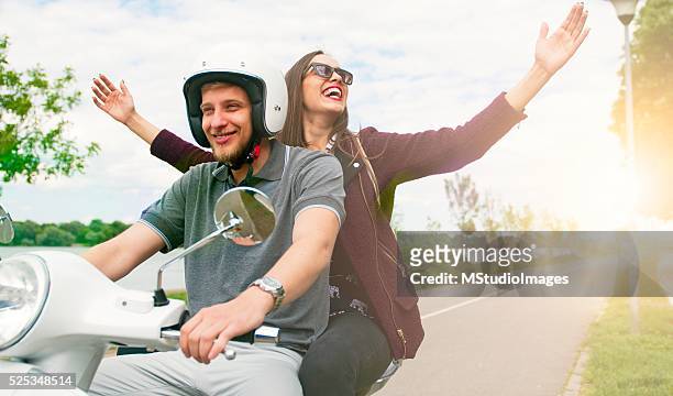 take me on the trip. - girl riding scooter stockfoto's en -beelden