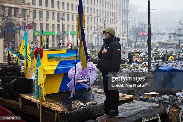 An activist of anti-government opposition sings the national anthem on the barricade in Kiev during a concert organized for the activists and for the...