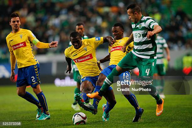 Sporting's defender Jefferson vies for the ball with Estoril's defender Mano and Estoril's midfielder Anderson during the Portuguese League football...