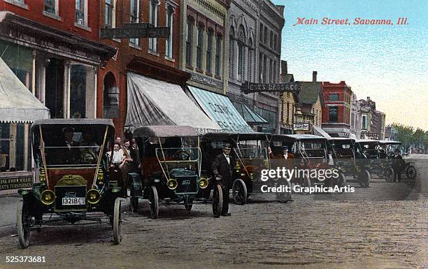 View of Main Street, Savanna, Illinois with rows of Model T cars; colored print from a photograph, 1916.