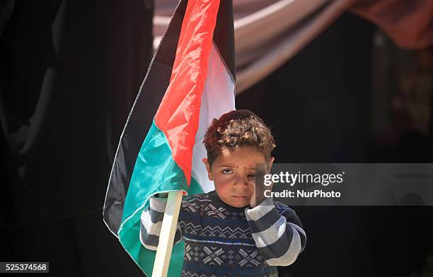 Palestinian child standing next a gathering In front of UN headquarters in gaza city in solidarity with the Palestinians living in Syria's Yarmouk...