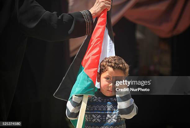 Palestinian child standing next a gathering In front of UN headquarters in gaza city in solidarity with the Palestinians living in Syria's Yarmouk...