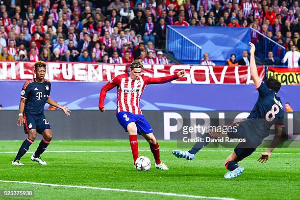 Fernando Torres of Atletico de Madrid competes for the ball with David Alaba and Javi Martinez of FC Bayern Muenchen during the UEFA Champions League...