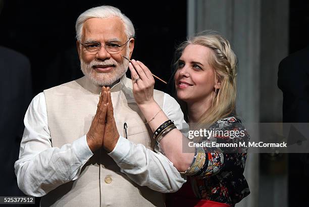 Madame Tussauds studio artist puts the finishing touches on new wax figure of Narendra Modi, Prime Minister of India as it joins World leaders...