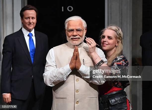 Madame Tussauds studio artist puts the finishing touches on new wax figure of Narendra Modi, Prime Minister of India as it joins World leaders...