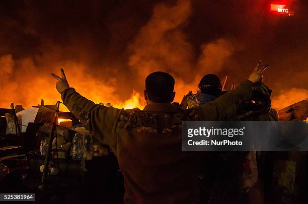 Kiev, UkraineMidnight on the Maidan, protesters at the barricades singing the Anthem of Ukraine. A barricade is created by protesters made of burning...