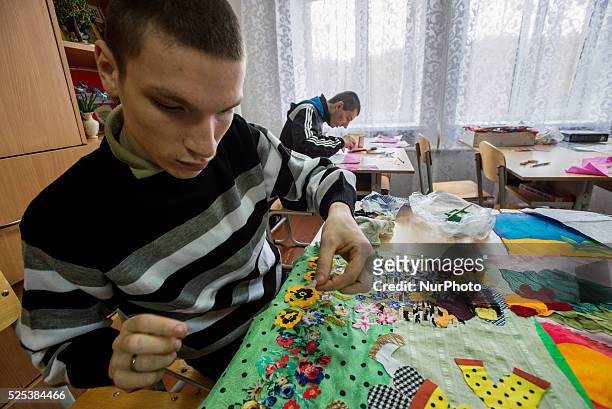 Boys with intellectual disability make textile applique in working class, Teterivka's Orphanage and Boarding school. Zhytomyr, Ukraine. 2 of...