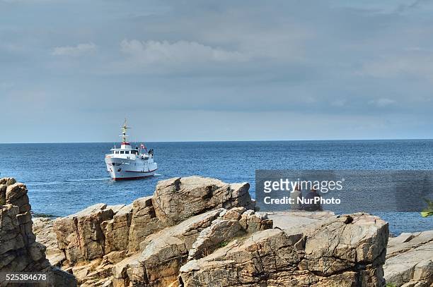 Denmark, Bornholm Island Pictures taken between 1st and 5th August 2014. Pictured: People sit on the rocks in the Gudhjem city at the Baltic sea...