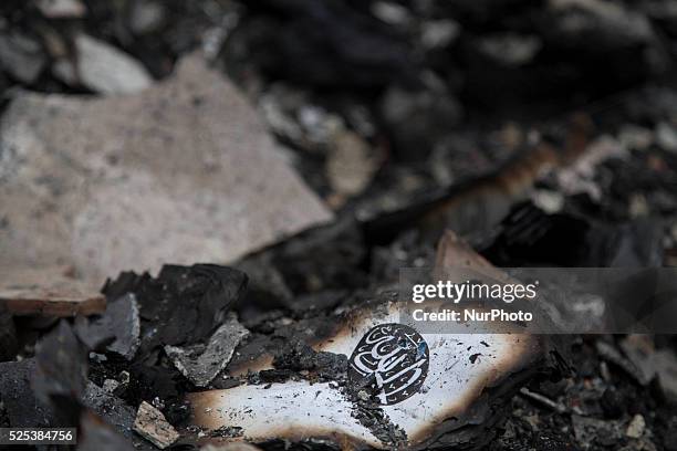 Burned Quran at the burn houses site. After big fire hit the slum area in Gandaria-South Jakarta, victim of the houses have not visitted by...
