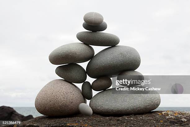 group of coastal stones balanced on top of each other - balance harmony stock pictures, royalty-free photos & images