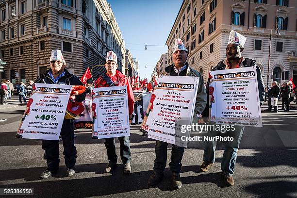 Members of the Italian trade union CGIL shout slogans and hold placards during a protest in Rome against the Italian government's plans to overhaul...