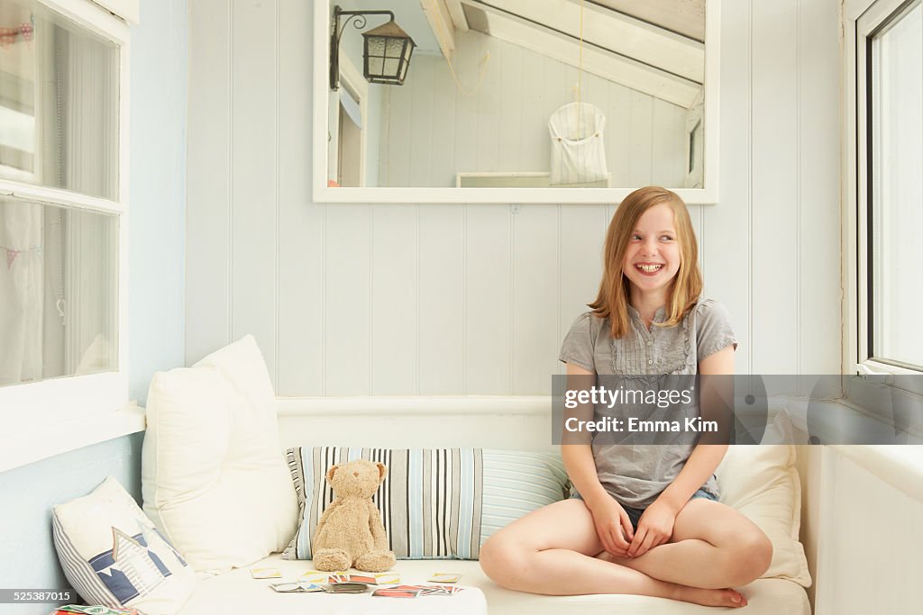 Portrait of girl looking sideways in holiday apartment porch