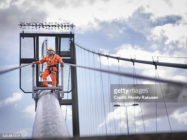 bridge worker on cable of suspension bridge. the humber bridge, uk was built in 1981 and at the time was the worlds largest single-span suspension bridge - humber bridge stock pictures, royalty-free photos & images