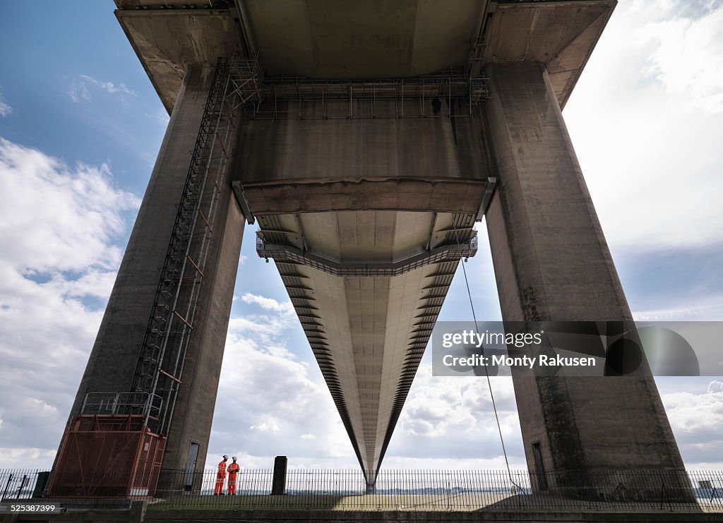 Bridge workers inspecting suspension bridge. The Humber Bridge, UK was built in 1981 and at the time was the worlds largest single-span suspension bridge