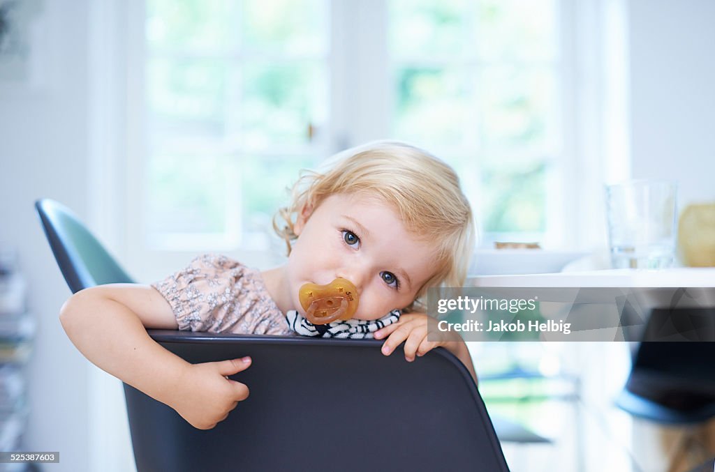 Portrait tired female toddler in living room