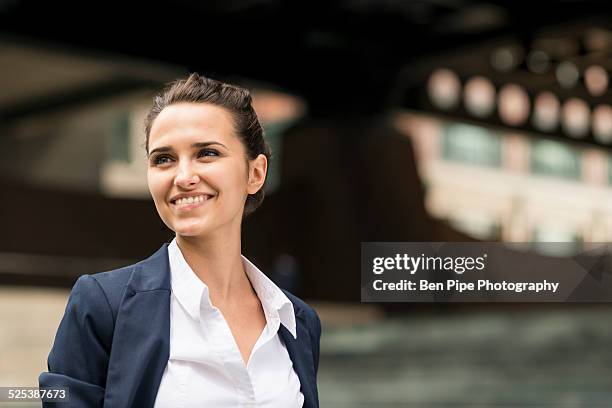 young businesswoman outside station with digital tablet, london, uk - businesswoman in suit jackets stock-fotos und bilder