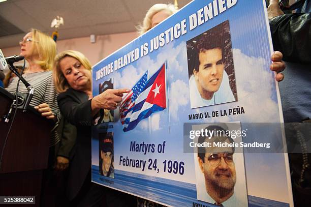 Rep. Ileana Ros-Lehtinen points to a poster with pictures of those lost from the group called 'Brothers to the Rescue' when they were shot down by...