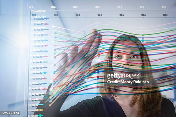 businesswoman inspecting graph on interactive display - big data white fotografías e imágenes de stock