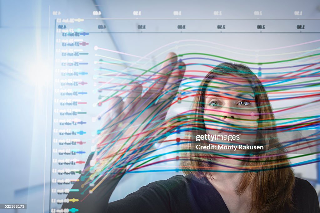 Businesswoman inspecting graph on interactive display