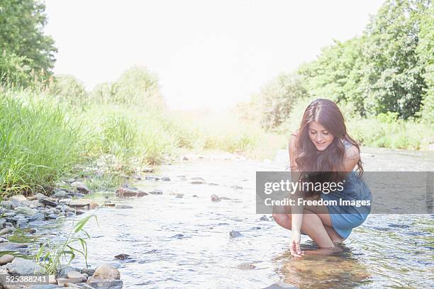young woman in shallow stream - ankle length stock pictures, royalty-free photos & images
