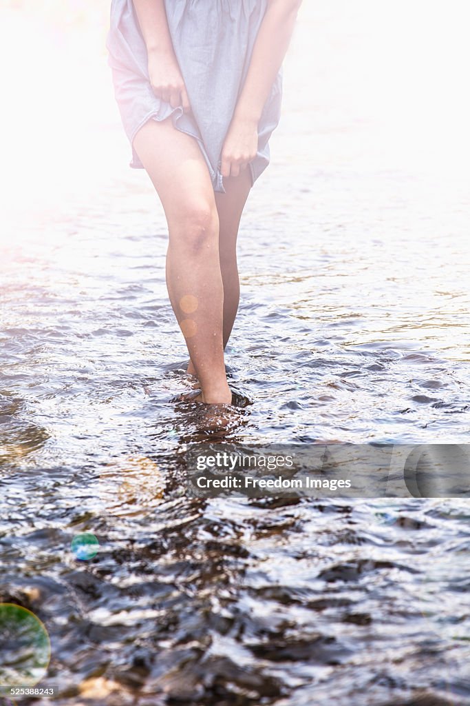 Young woman in shallow stream