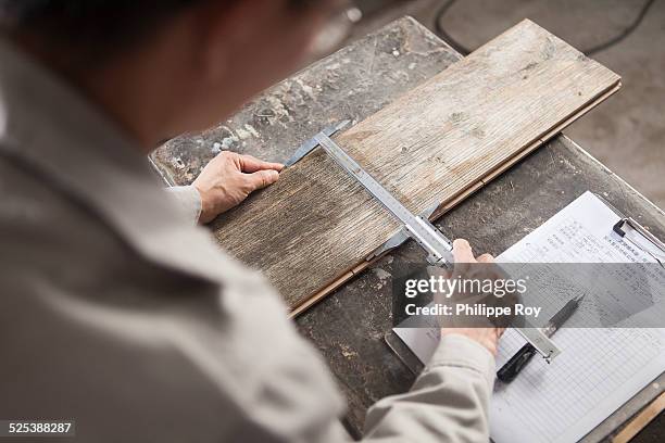 carpenter measuring wood plank with vernier caliper in factory, jiangsu, china - nantong stock pictures, royalty-free photos & images