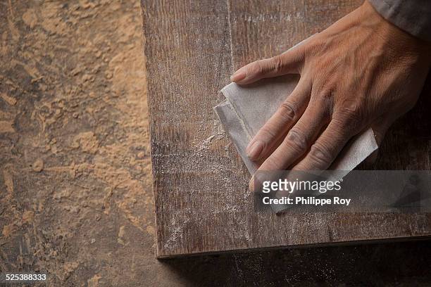 carpenter smoothing surface of wood plank with sandpaper in factory, jiangsu, china - sand paper stock pictures, royalty-free photos & images