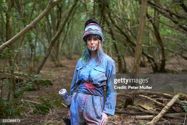 paintball player in paintball wear marked with paint - paintball stock pictures, royalty-free photos & images