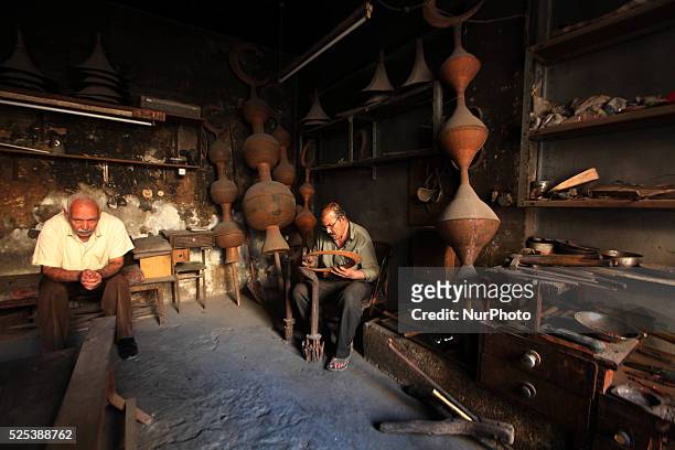 Gaza, Palestine on June 20, 2015 Mohammed Abdo in 53 -year-old works copper industry inherited this profession from his father for nearly 40 years ....