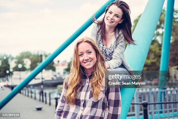 portrait of two smiling young female best friends - sean malyon stock pictures, royalty-free photos & images