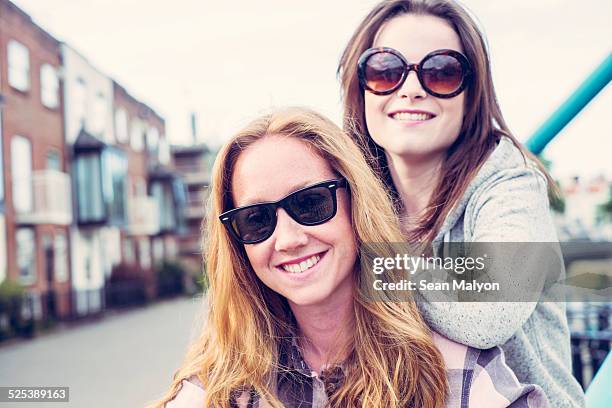 portrait of two young female best friends in sunglasses - sean malyon stock pictures, royalty-free photos & images