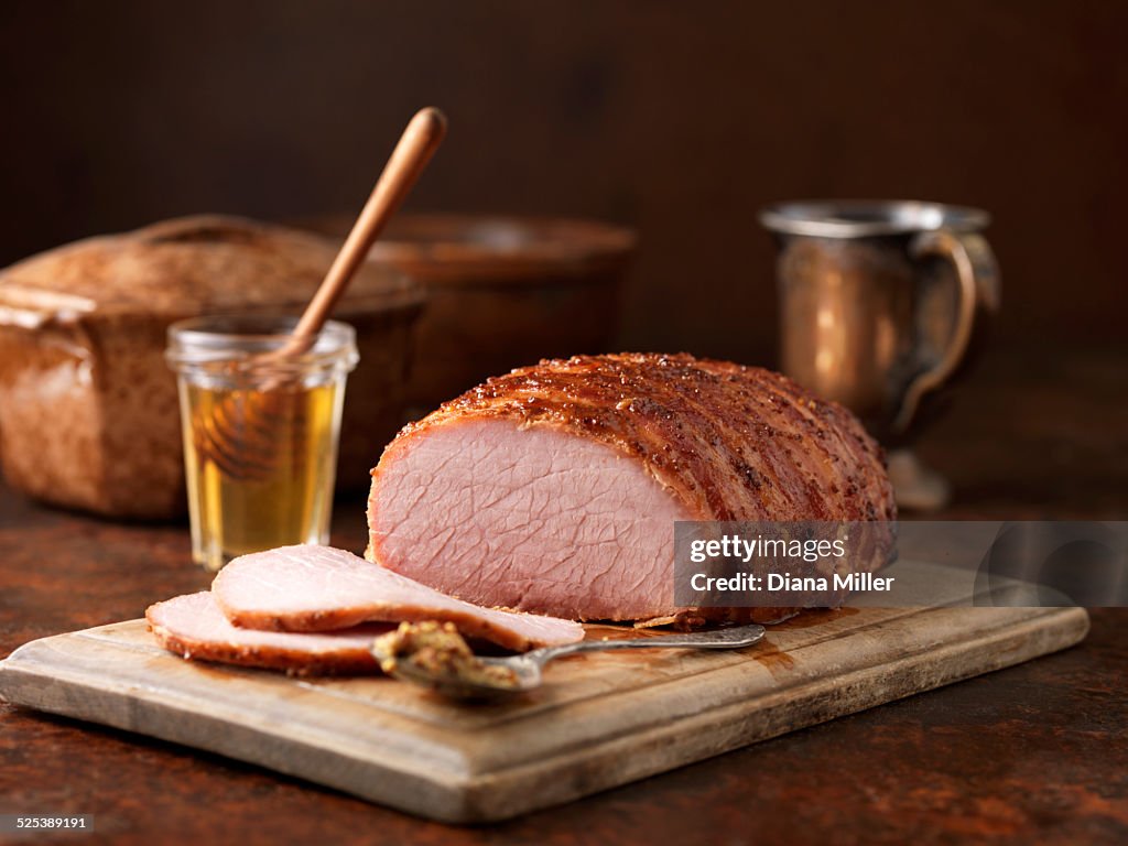 Christmas dinner. Honey and wholegrain mustard gammon on chopping board