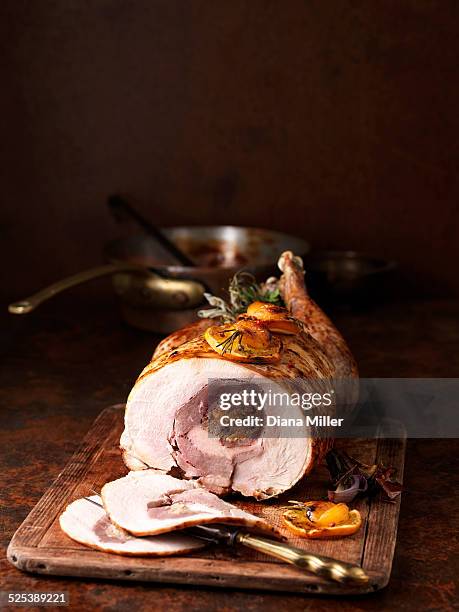 christmas dinner. four bird roast with red onions, rosemary, orange, apricot and mixed herbs - roasted red onion fotografías e imágenes de stock