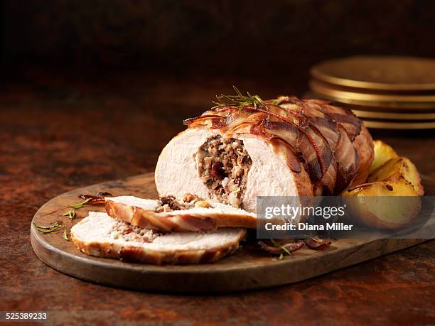 christmas dinner. turkey breast with pork, apple & cranberry stuffing and rosemary - turkey cooked stock-fotos und bilder