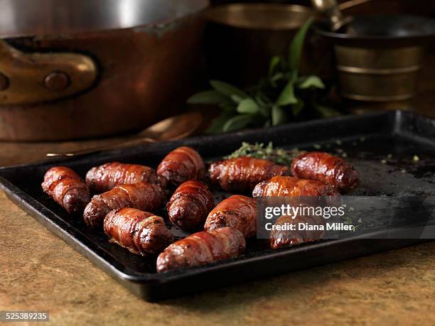 christmas dinner snack. festive spiced bacon and venison cocktail sausage rolls. pigs in blankets with thyme bay leaves - christmas pigs in blankets stock pictures, royalty-free photos & images