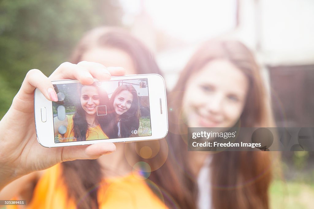 Young women taking selfie on smartphone