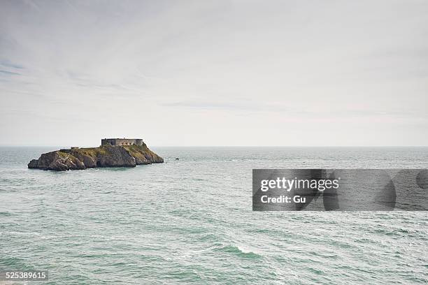 distant view of st catherines island and fort, tenby, wales - tenby wales stock pictures, royalty-free photos & images