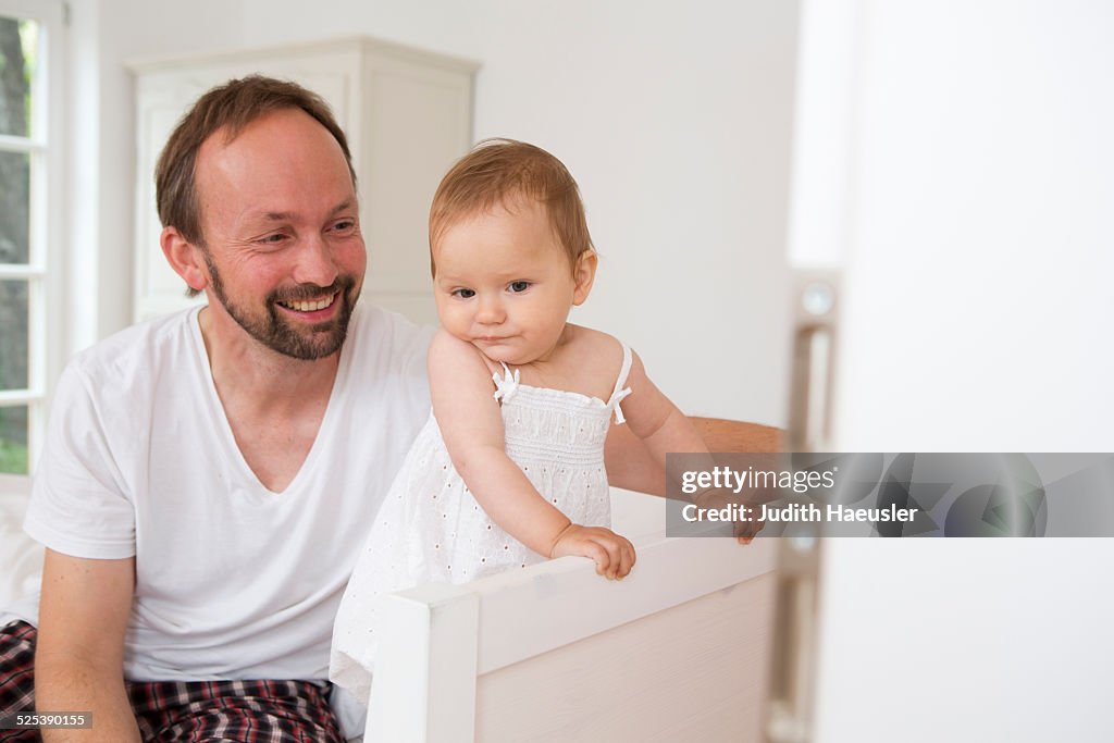 Father smiling at baby daughter