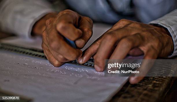 Blind, learns Braille writing at Abhedananda Home, a school for deaf, dumb and blind students on September 01, 2015 in Srinagar, the summer capital...