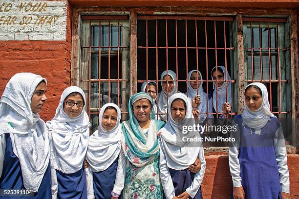 Arshida Siddiqui, a senior teacher who herself is not disable poses for a picture with her deaf and dumb students with the help of signs at...