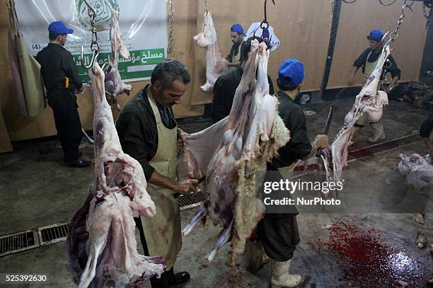 Syrians slaughter sheep during the Muslim holiday of Eid al-Adha , which commemorates Abraham's willingness to sacrifice his son for God . Rif...