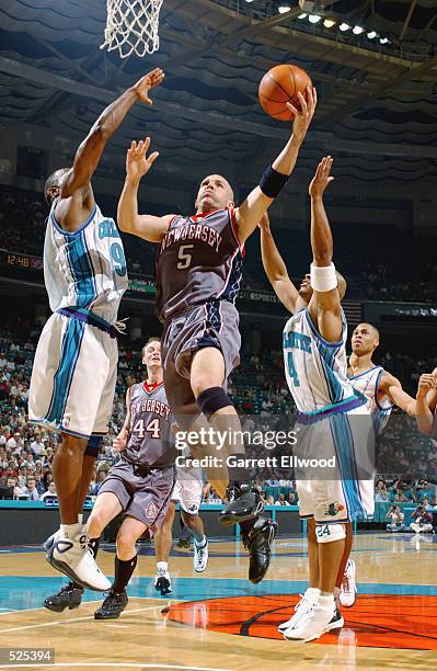 Point guard Jason Kidd of the New Jersey Nets shoots over forward George Lynch of the Charlotte Hornets during game four of the Eastern Conference...