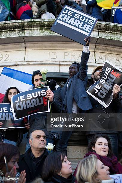 People holding cardboards reading &quot;Je suis Charlie take part in a Unity rally "Marche Republicaine" on the Place de la Republique in Paris on on...