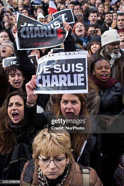 People holding cardboards reading &quot;Je suis Charlie take part in a Unity rally "Marche Republicaine" on the Place de la Republique in Paris on on...