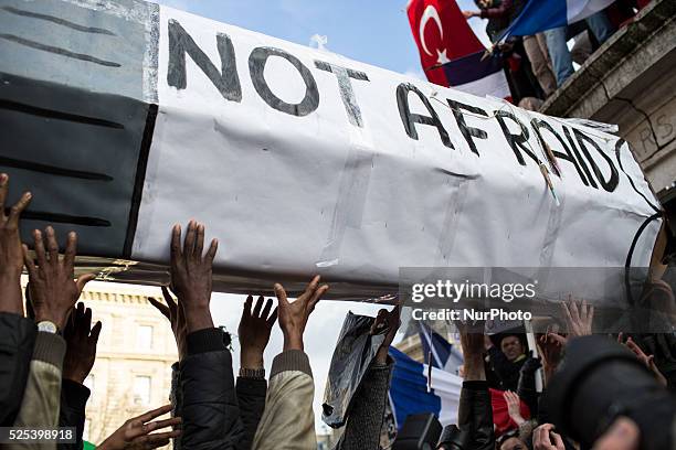 People holding cardboards reading &quot;Je suis Charlie take part in a Unity rally "Marche Republicaine" on the Place de la Republique in Paris on on...