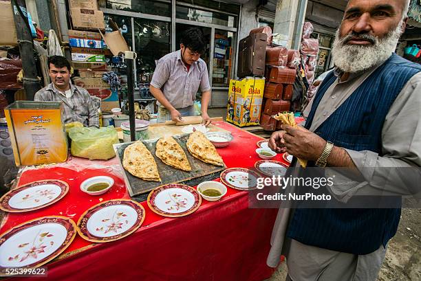 Street vendor cooks and sells bolani on Bazaar in Old city of Kabul, Afghanistan