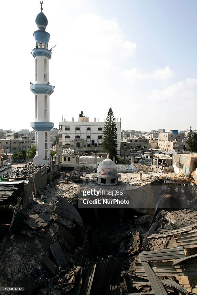 Palestinians inspect the destruction in Farouq Mosque after a an Israeli air strike in Rafah