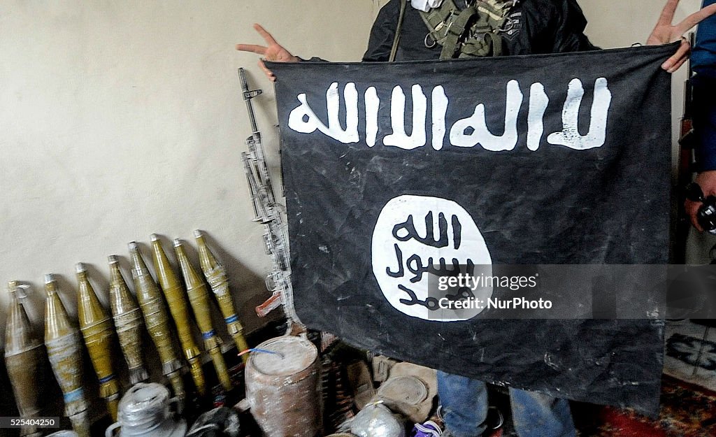 Kurdish Defenders Show Islamic State Flag Captured In Battle Along With Weapons Cache